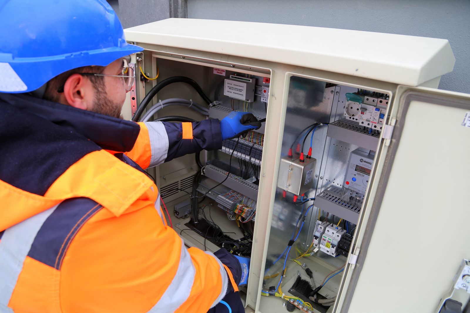 Electrician at a fuse box
